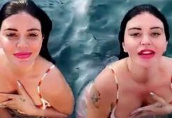Ebru Polat kıyafetleriyle denize girdi