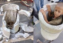 Beton çöp kovasına sıkışan çocuk güçlükle kurtarıldı