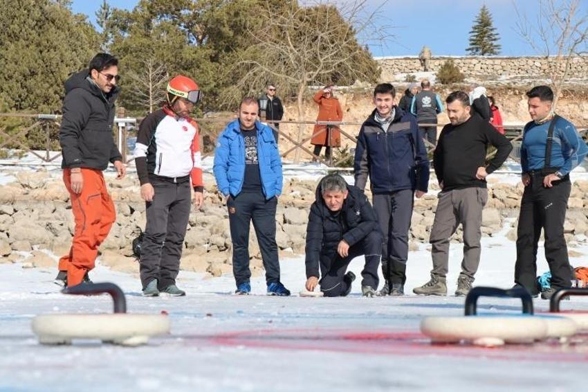 Donmuş gölü spreyle boyayıp curling oynadılar!